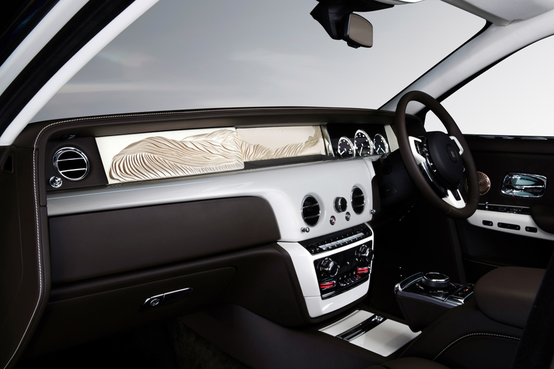 The “Whispered Muse” Phantom has an art adaptation in it that Rolls-Royce calls a “sculpted silk adaptation of the Spirit of Ecstasy,” its hood emblem. It was done by British artist Helen Amy Murray.